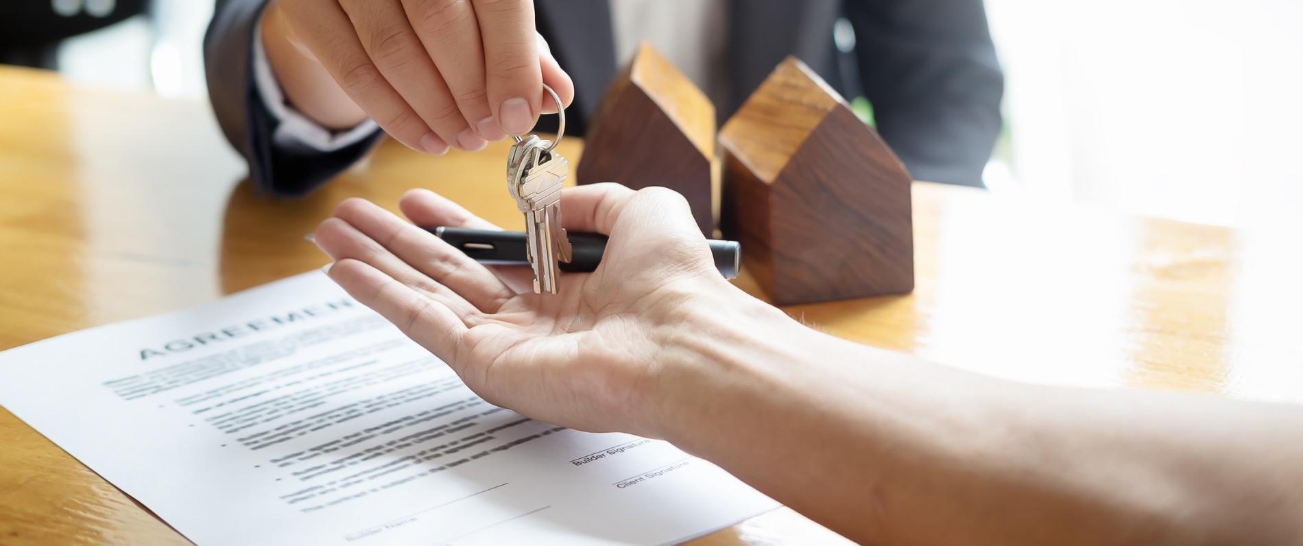 real estate handing house keys to a client