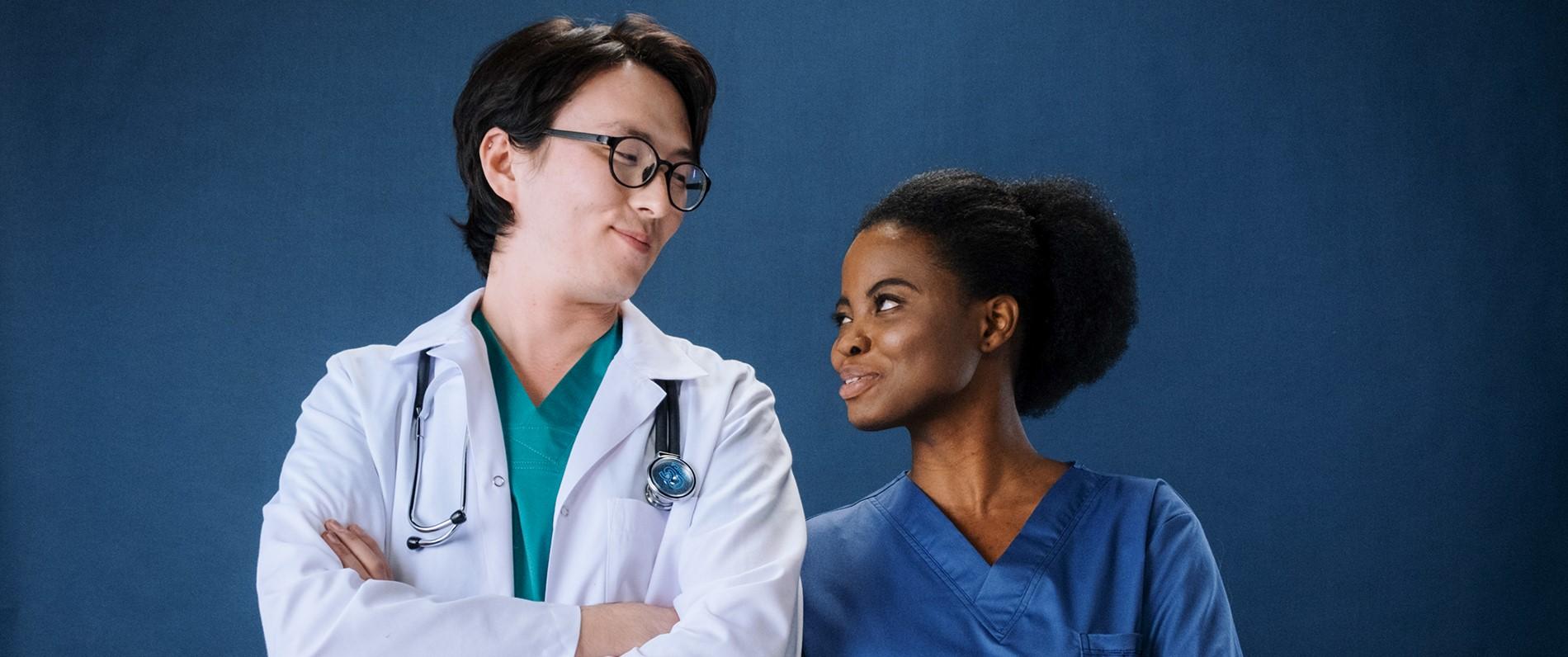 A student in the LPN to RN program smiles with a doctor