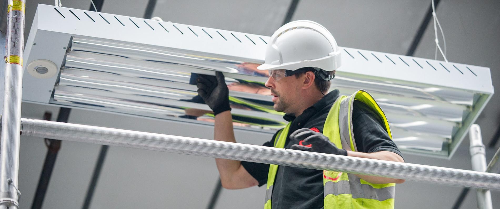a limited maintenance electrician apprentice with a hard hat working