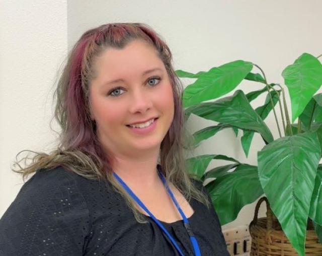 Mayme Stearns, a Career Pathway Coach with kind eyes and tattoos