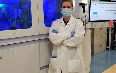 A science student proudly standing in a lab