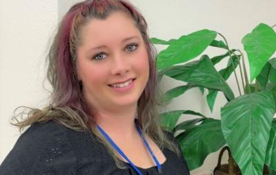 Mayme Stearns, a Career Pathway Coach with kind eyes and tattoos 