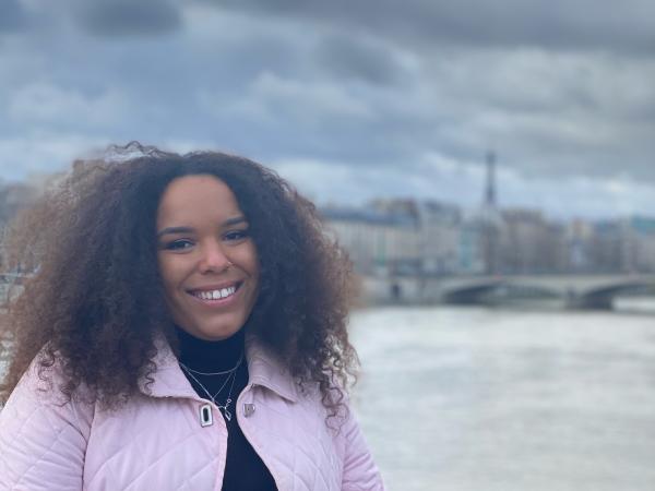 Alum standing at a bridge with Eiffel Tower in background