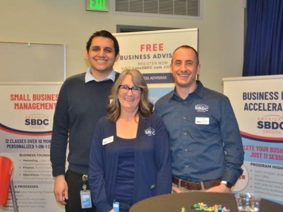 three friendly employees of Lane SBDC at an event