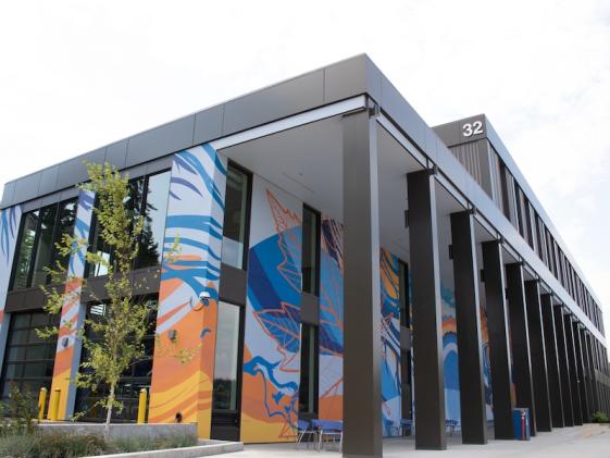 Building 32, home of the dental clinic, EMT, and other health professions, with a colorful blue and yellow mural