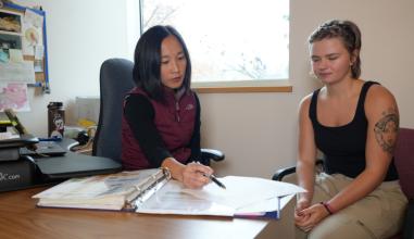 A woman advising a young woman