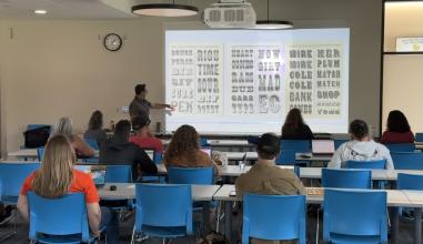 Tom Madison, a graphic designer, instructs high school CTE art teachers on typography
