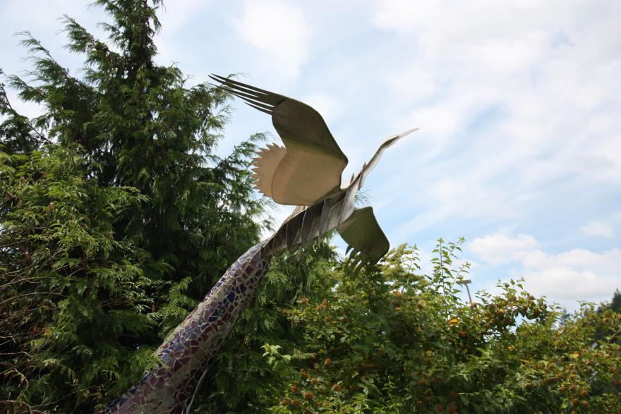 sculpture of a bird in flight on lane campus