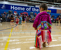 Native american child in regalia at pow wow