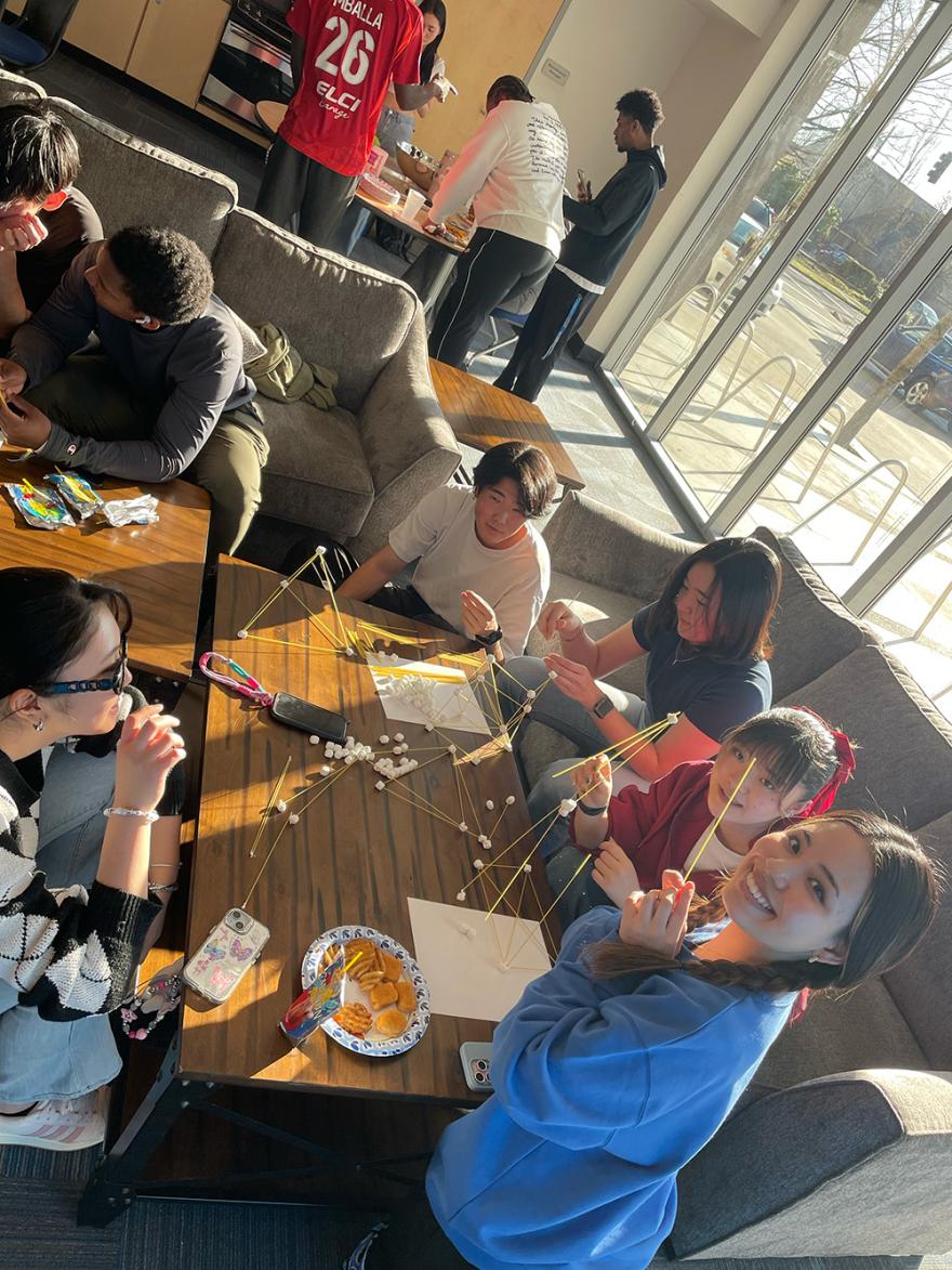 students hang out at Titan Court, laughing and doing arts and crafts
