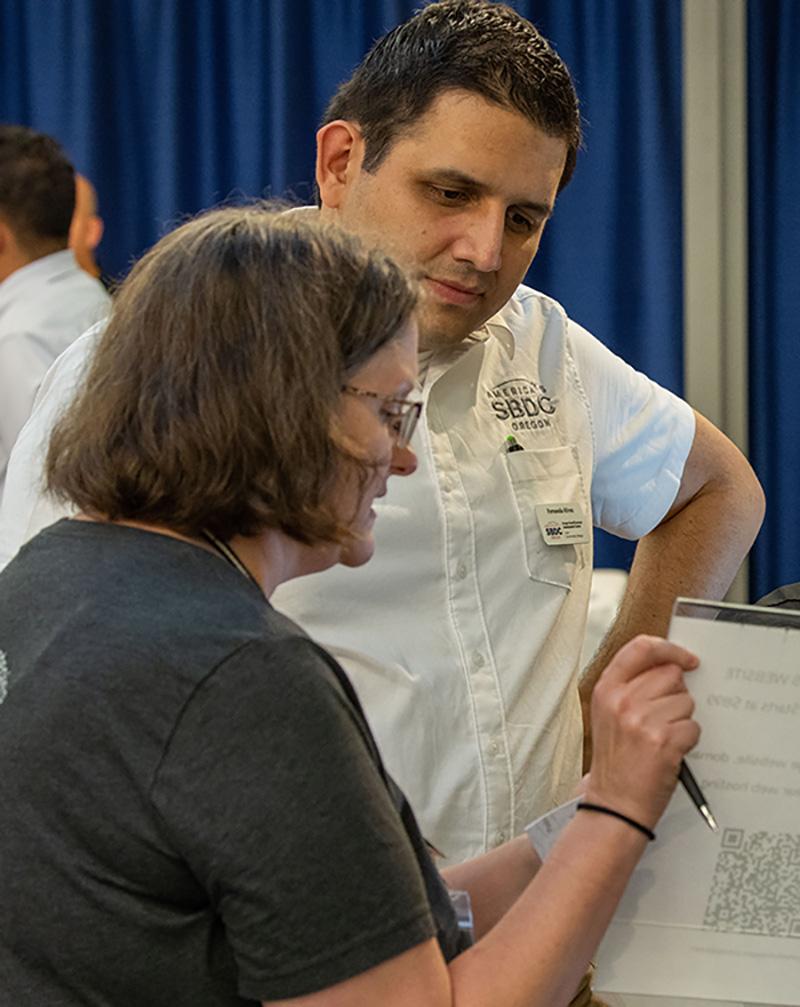 Fernando, a Spanish-speaking SBDC employee, helping a client