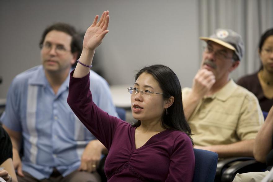 woman asking a question at a meeting