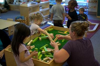 students playing with blocks with parent