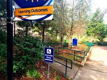 Image of accessible ramp and sign on LCC campus.