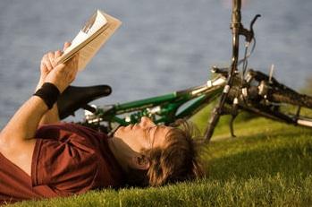 Bicyclist resting next to bike