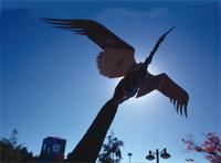 Crane sculpture by buses on main campus