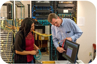 professor and student examining computer wires