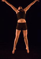 student performer dancing and leaping during performance