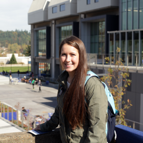 A smiling student in front of the Lane Community College campus.