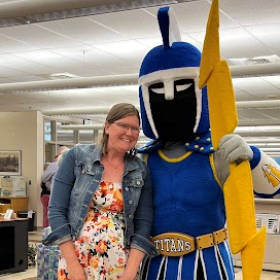 Brenda Williams standing next to Ty the Titan mascot