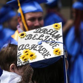 Dream, Believe, Achieve, written on a graduation cap