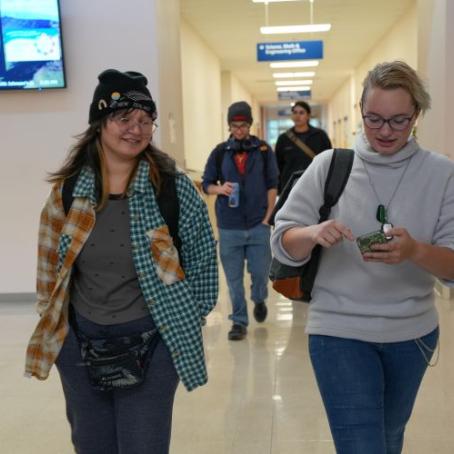 Students talking to each other and walking to class in the science building