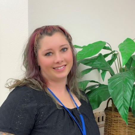 Mayme Stearns, a Career Pathway Coach with kind eyes and tattoos 