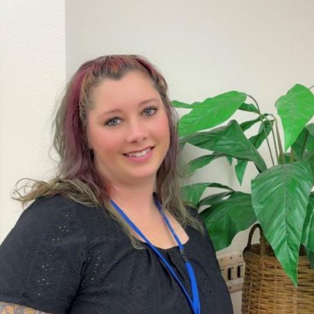 Mayme Stearns, a Career Pathway Coach with kind eyes and tattoos 