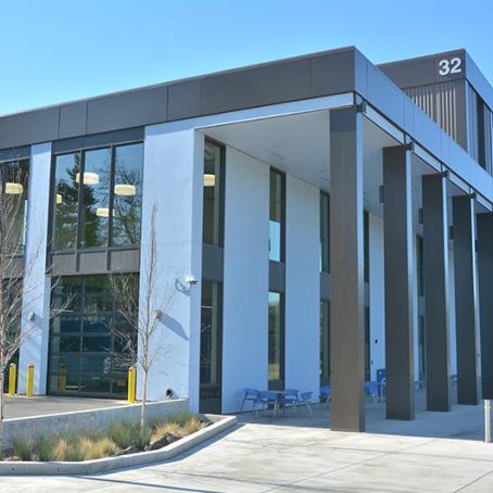 the exterior of the Health Professions building on a sunny day showing the ambulance bay