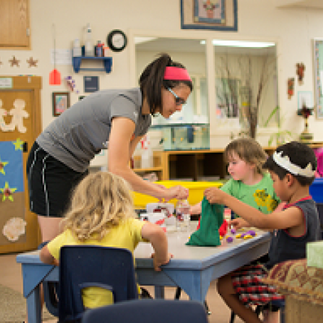 teacher and children reading a book