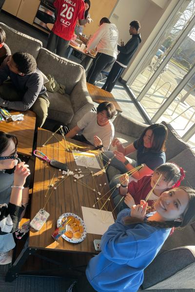students hang out at Titan Court, laughing and doing arts and crafts